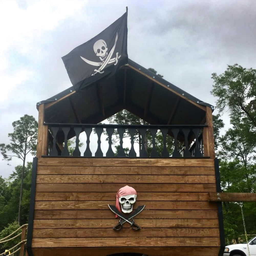 The 3x5 Ft Pirate Flag displayed in a garden setting