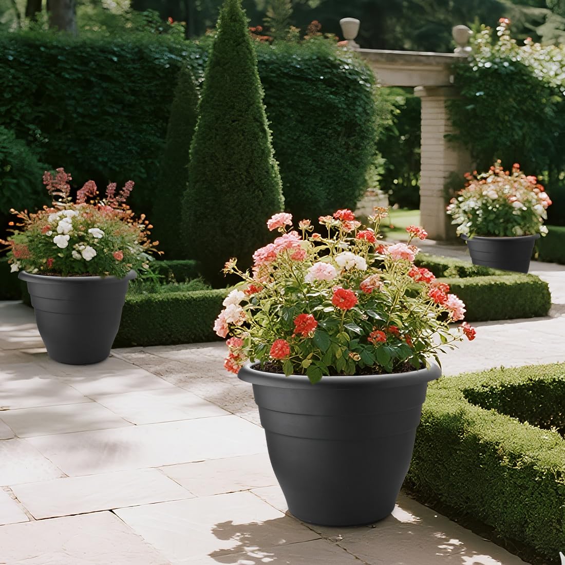 Three RooTrimmer 20 Inch Large Plant Pots arranged in a garden