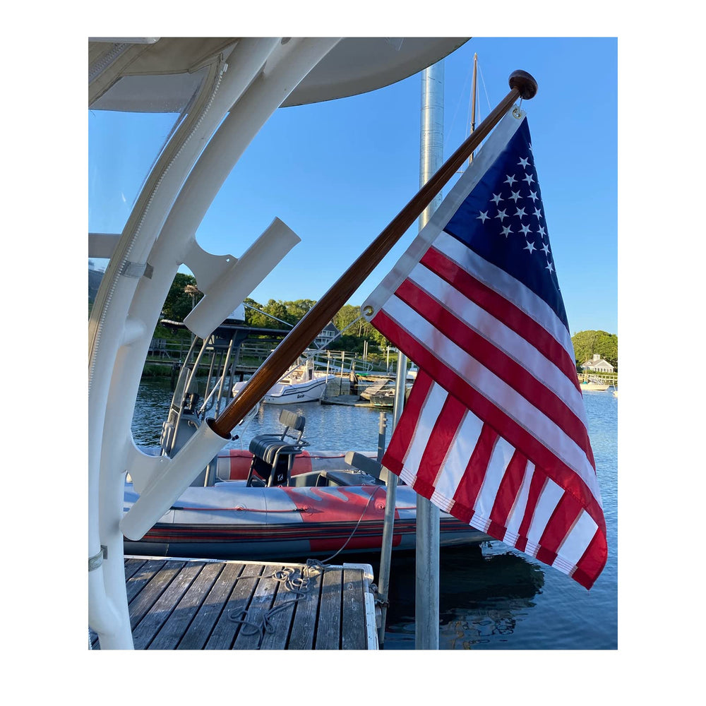 TOPFLAGS American Flag 12x18 inch displayed outdoors in a garden