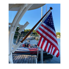 TOPFLAGS American Flag 12x18 inch displayed outdoors in a garden
