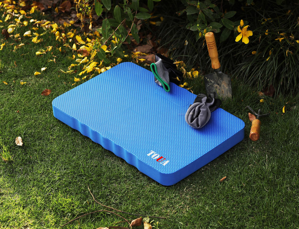 TOUA kneeling pad shown with plants and gardening tools