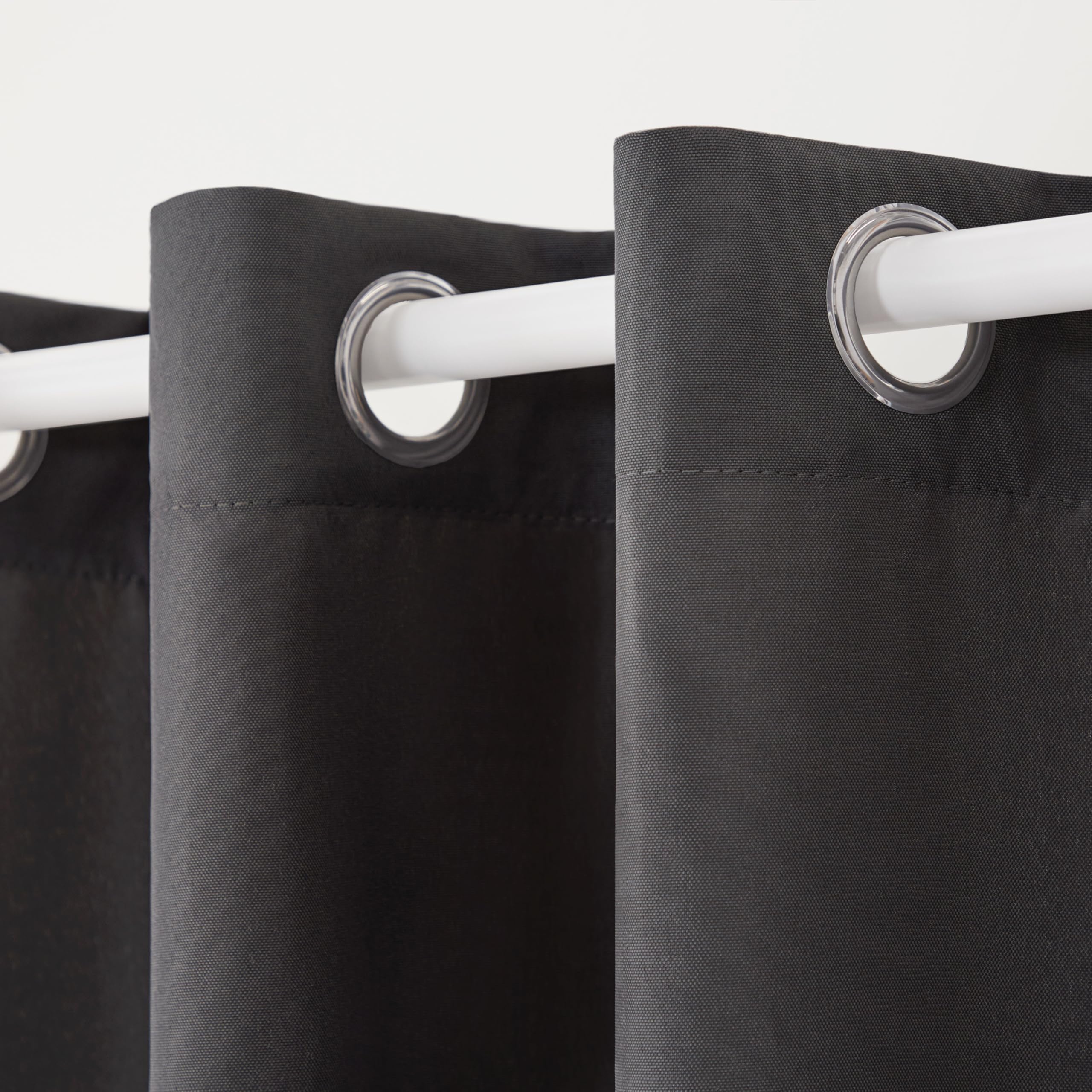 TOWN & COUNTRY BASICS Cabana Heavyweight Curtains hanging on a patio