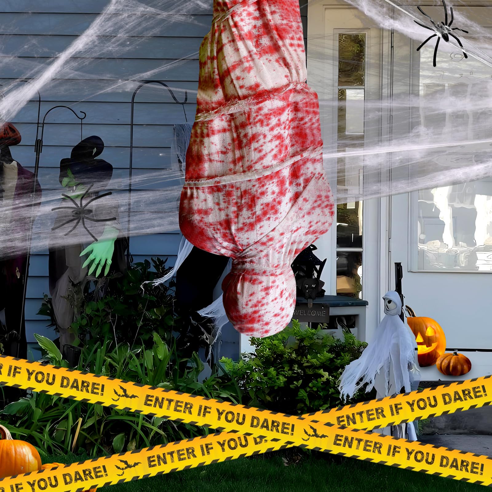 Two 6ft inflatable corpses displayed in a spooky yard