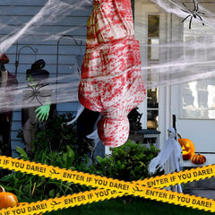 Two 6ft inflatable corpses displayed in a spooky yard