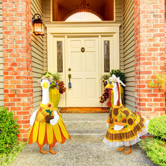 Two Abbylike sunflower porch goose outfits displayed together
