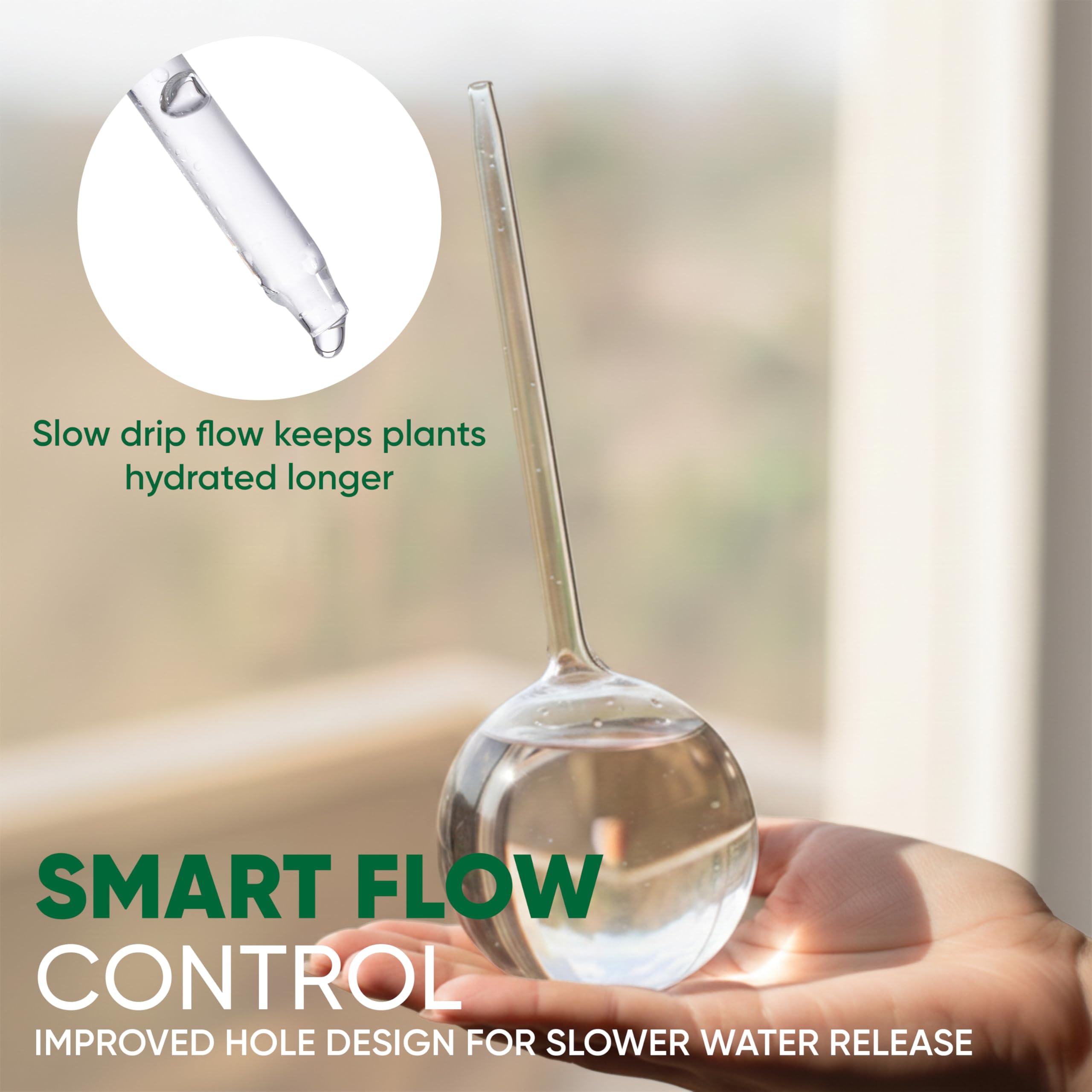 Two clear watering globes next to potted plants