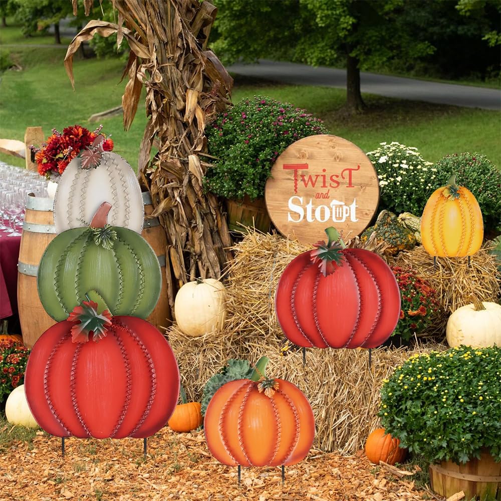 Two decorative garden stakes with pumpkins ready for installation