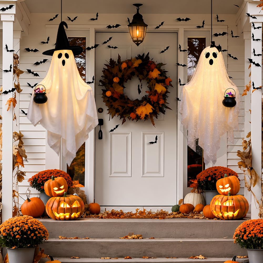 Two ghost decorations lit up at night