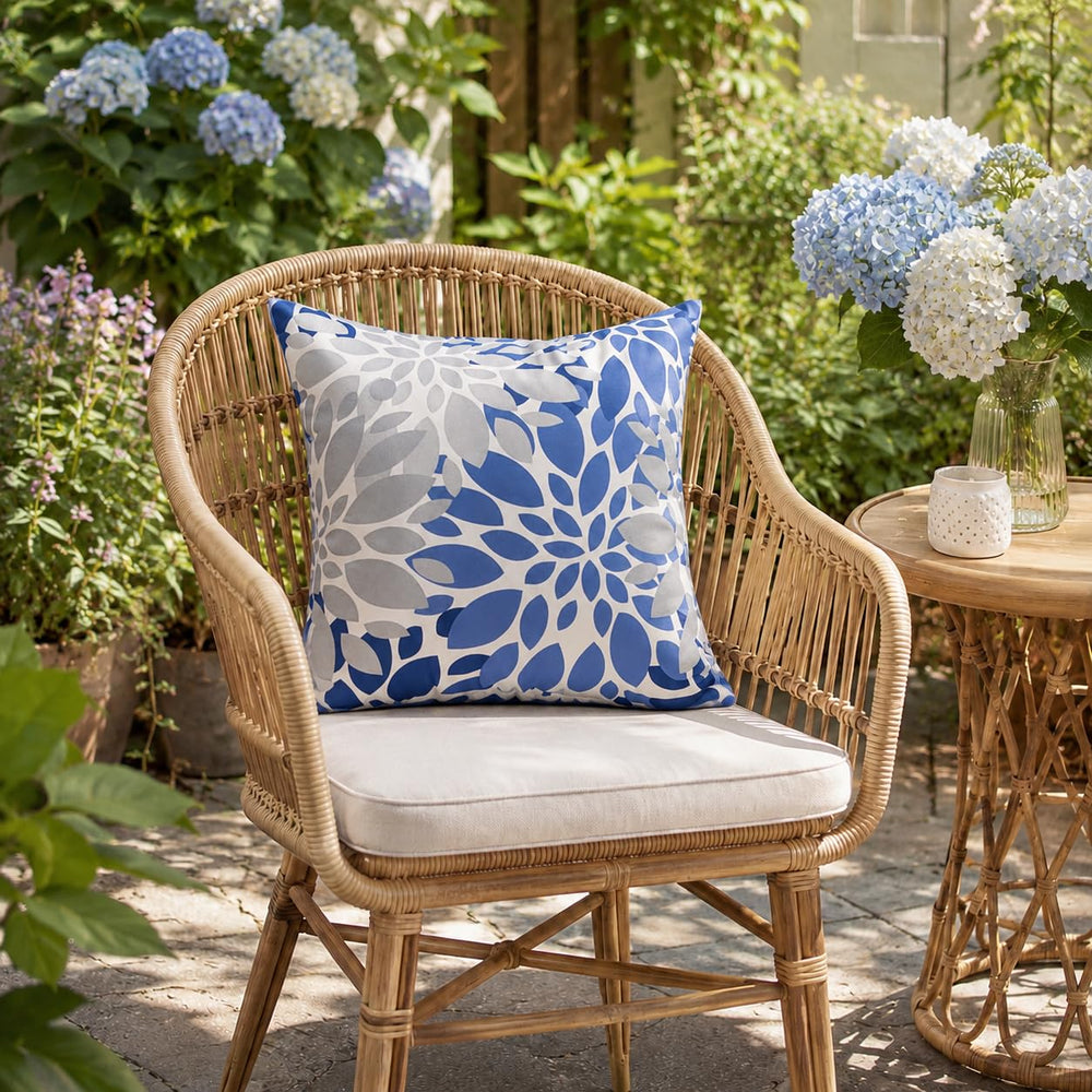 Two JMKaixin outdoor pillows arranged on a garden bench