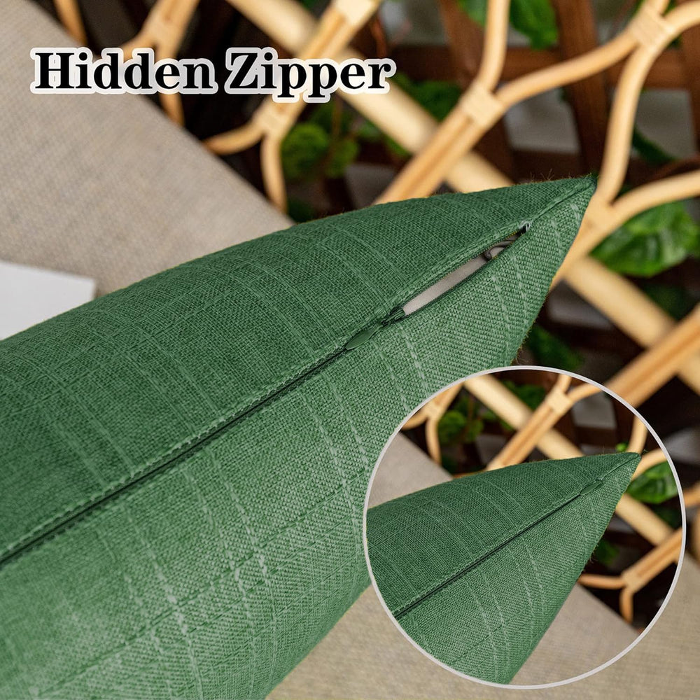 Two K KEVIN TEXTILE dark green pillow covers on a patio chair
