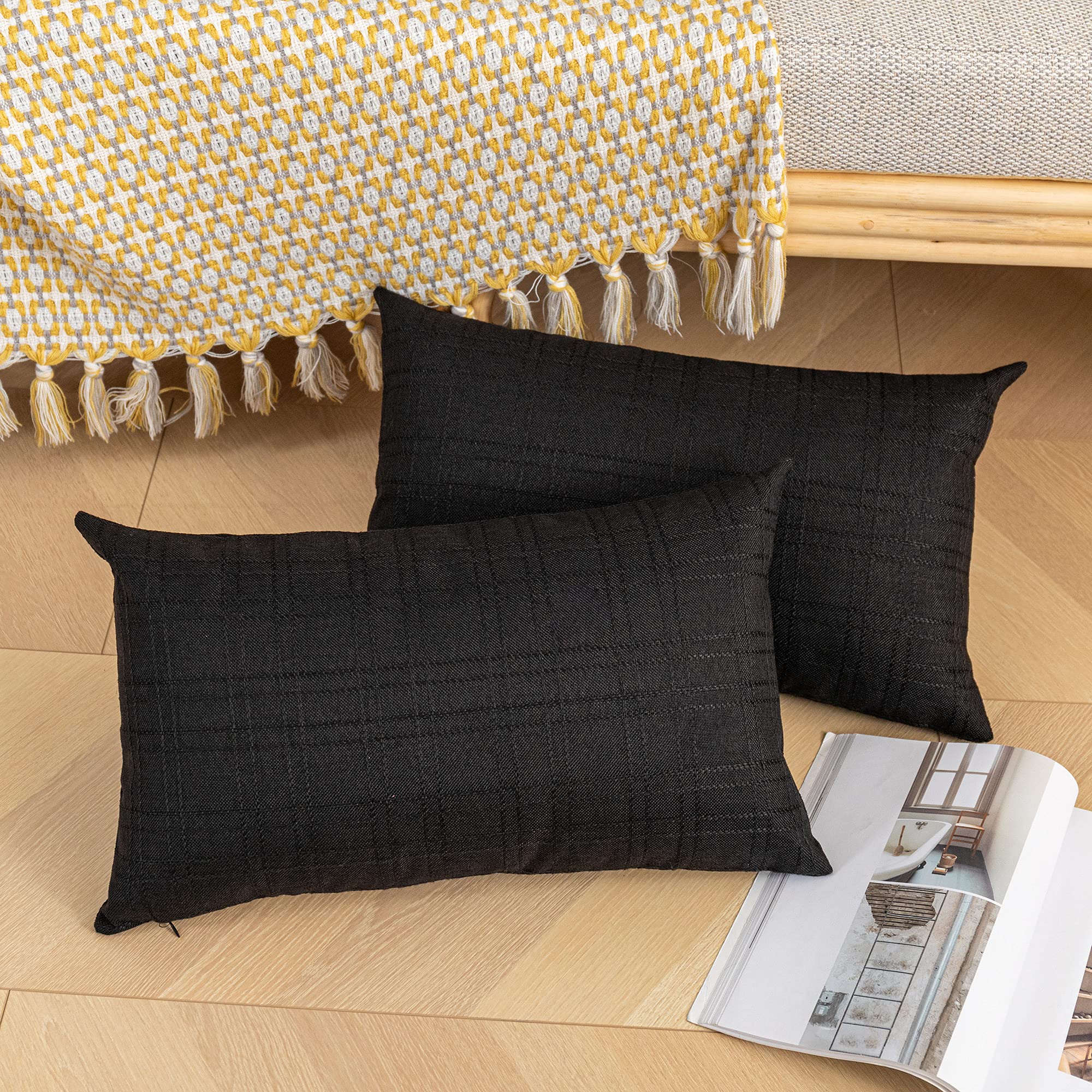 Two K KEVIN TEXTILE Lumbar Pillow Covers stacked on a patio chair