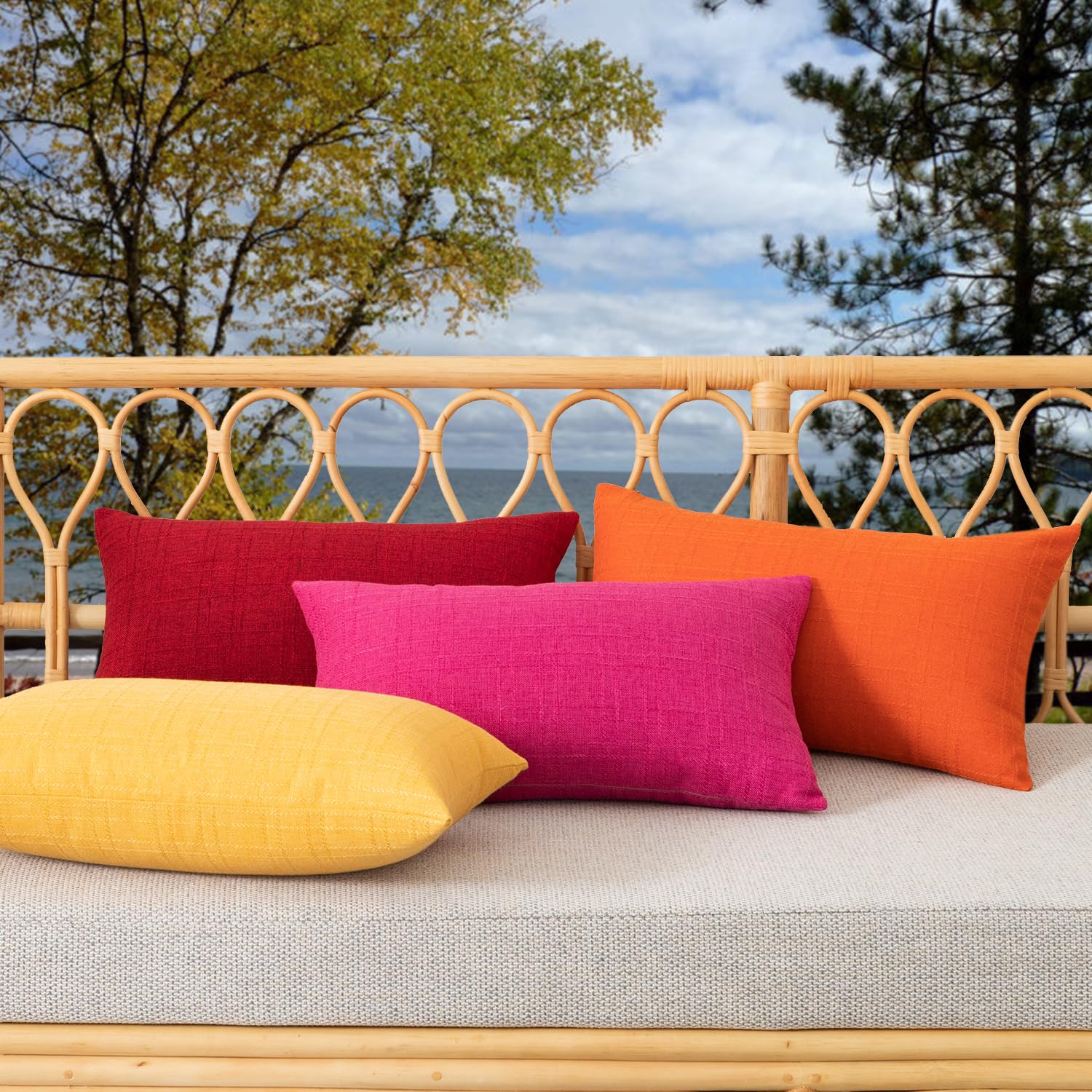 Two K KEVIN TEXTILE Outdoor Waterproof Lumbar Pillow Covers in red on a garden bench