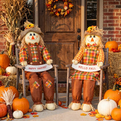 Two Libima 60" scarecrows sitting on a porch