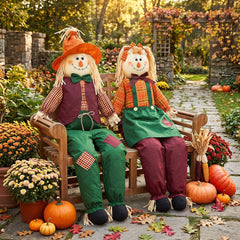 Two Libima scarecrows in a garden setting