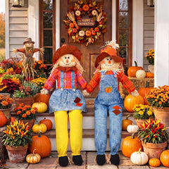 Two Libima scarecrows sitting in a garden setting
