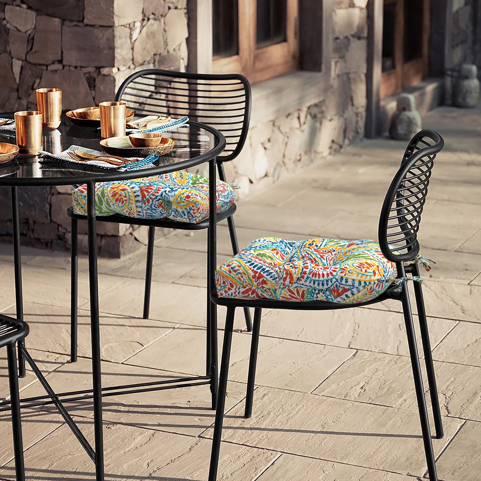 Two LVTXIII cushions displayed on patio furniture