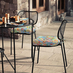 Two LVTXIII cushions displayed on patio furniture