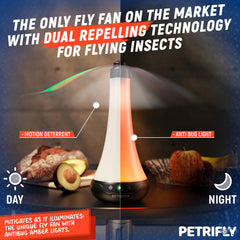 Two PETRI Fly Fans set up on an outdoor picnic table