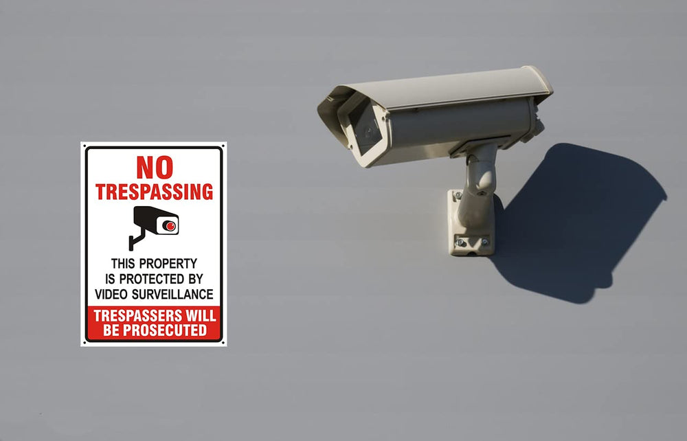 Two Poicrm No Trespassing Signs displayed together