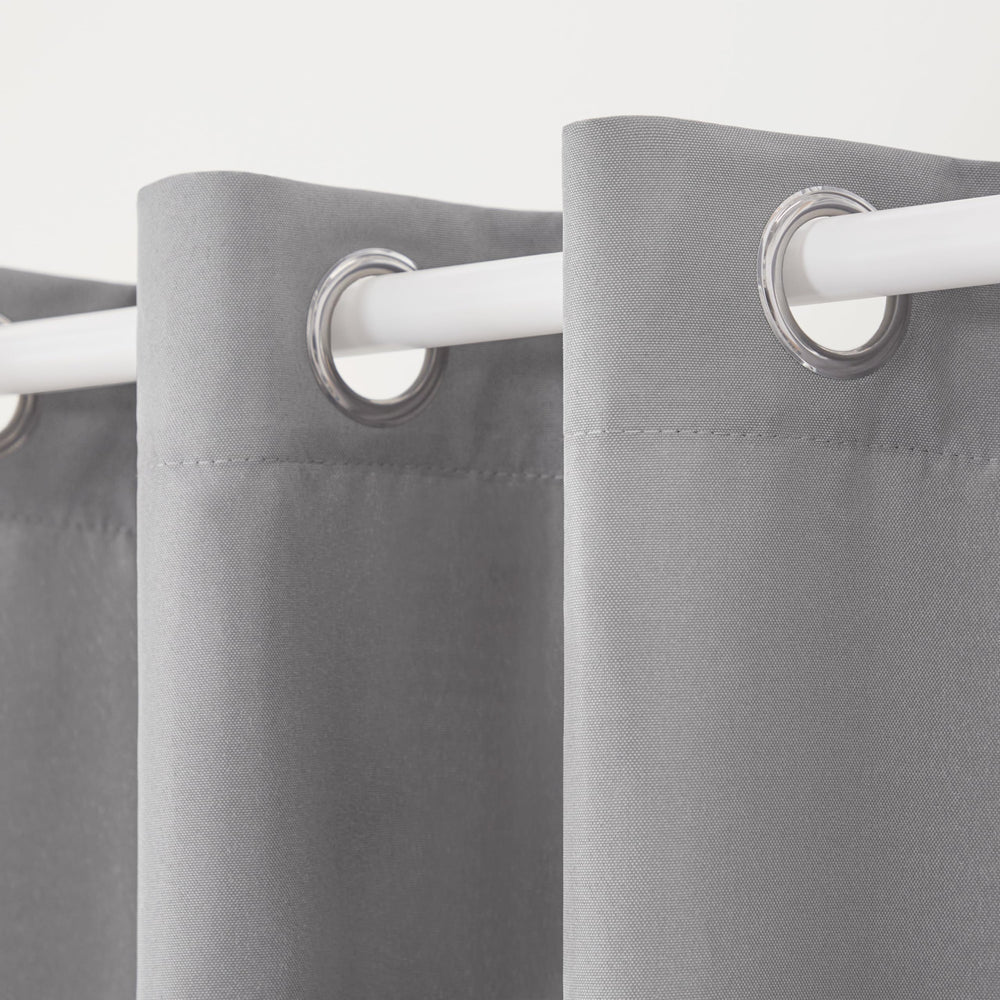 Two TOWN & COUNTRY BASICS Cabana Solid Heavyweight Curtain Panels displayed outdoors