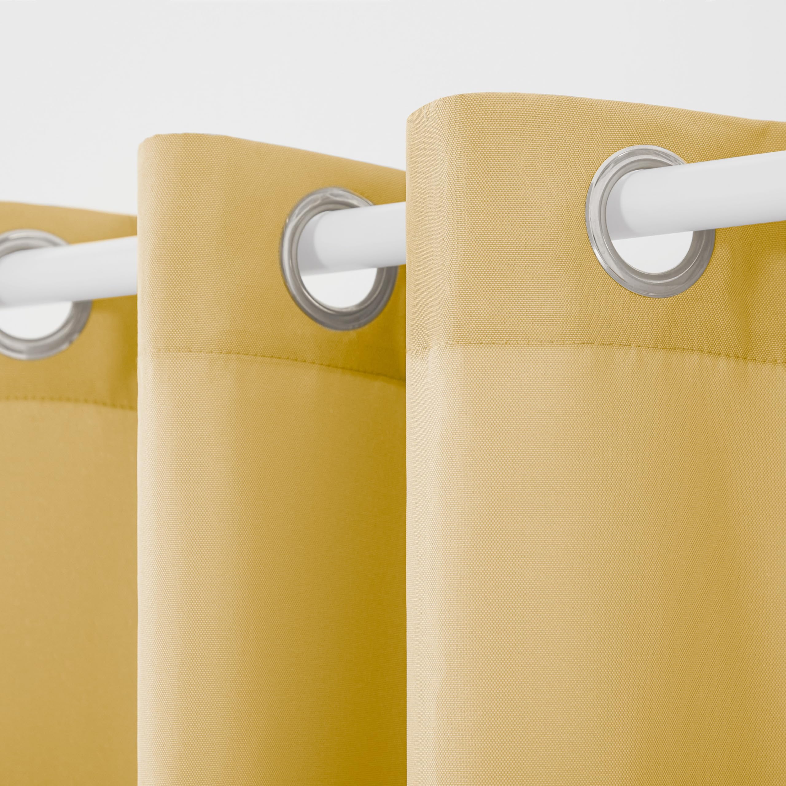 Two TOWN & COUNTRY BASICS curtain panels hanging on a patio
