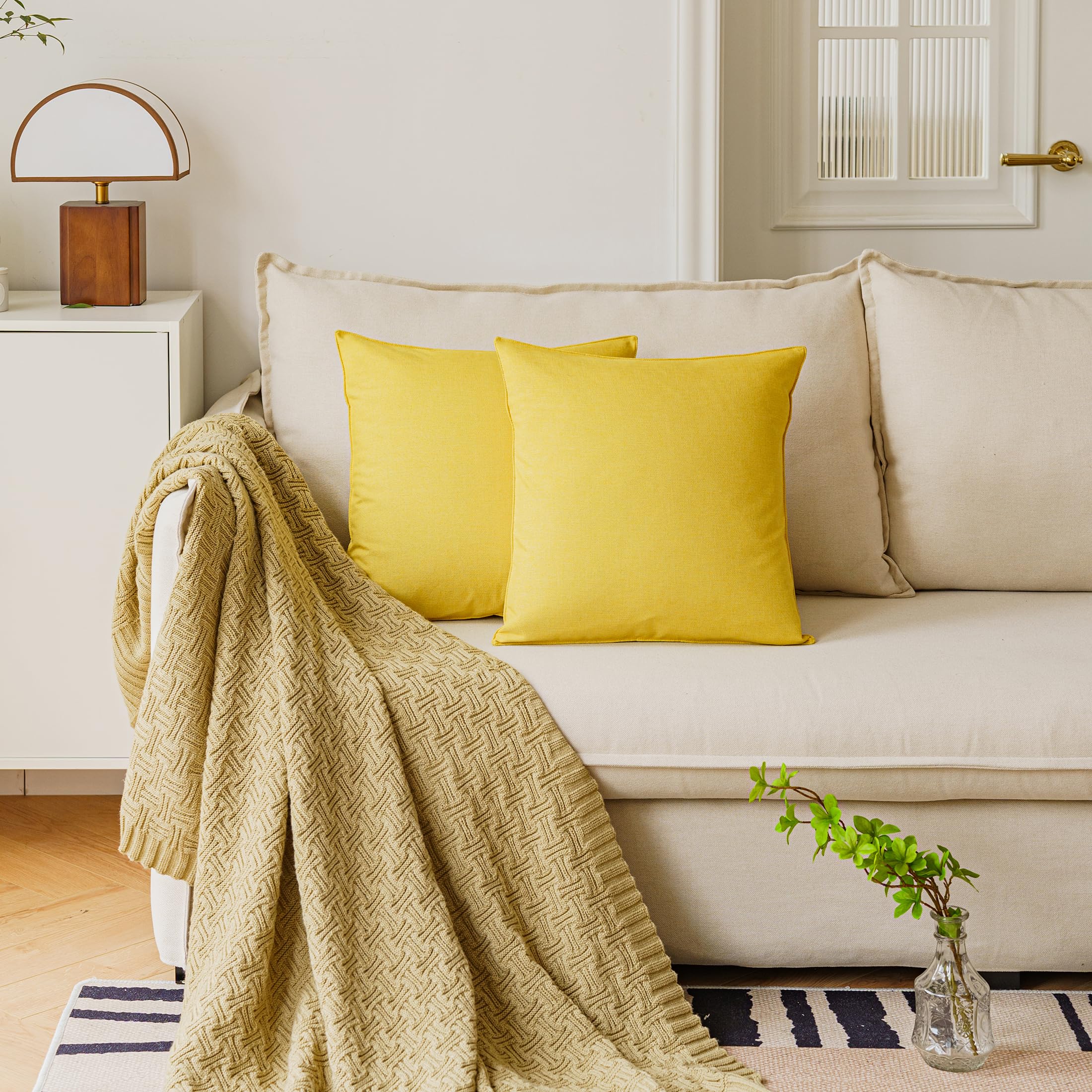 Two yellow NiNi ALL pillow covers stacked