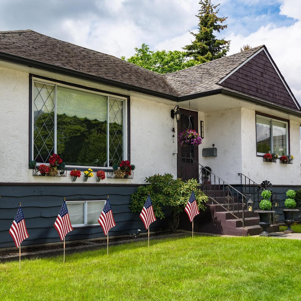 Uelfbaby flags arranged in a yard for Memorial Day