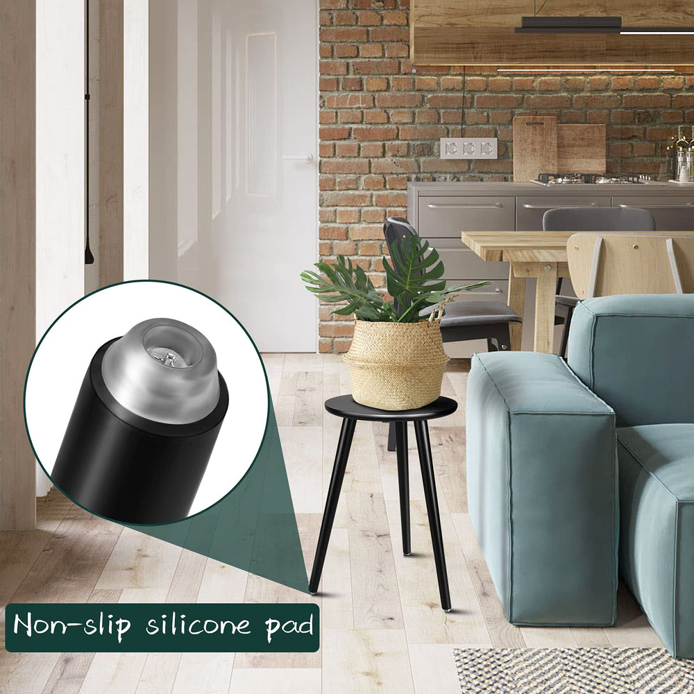 Uneedem plant stand used as a small table beside a sofa