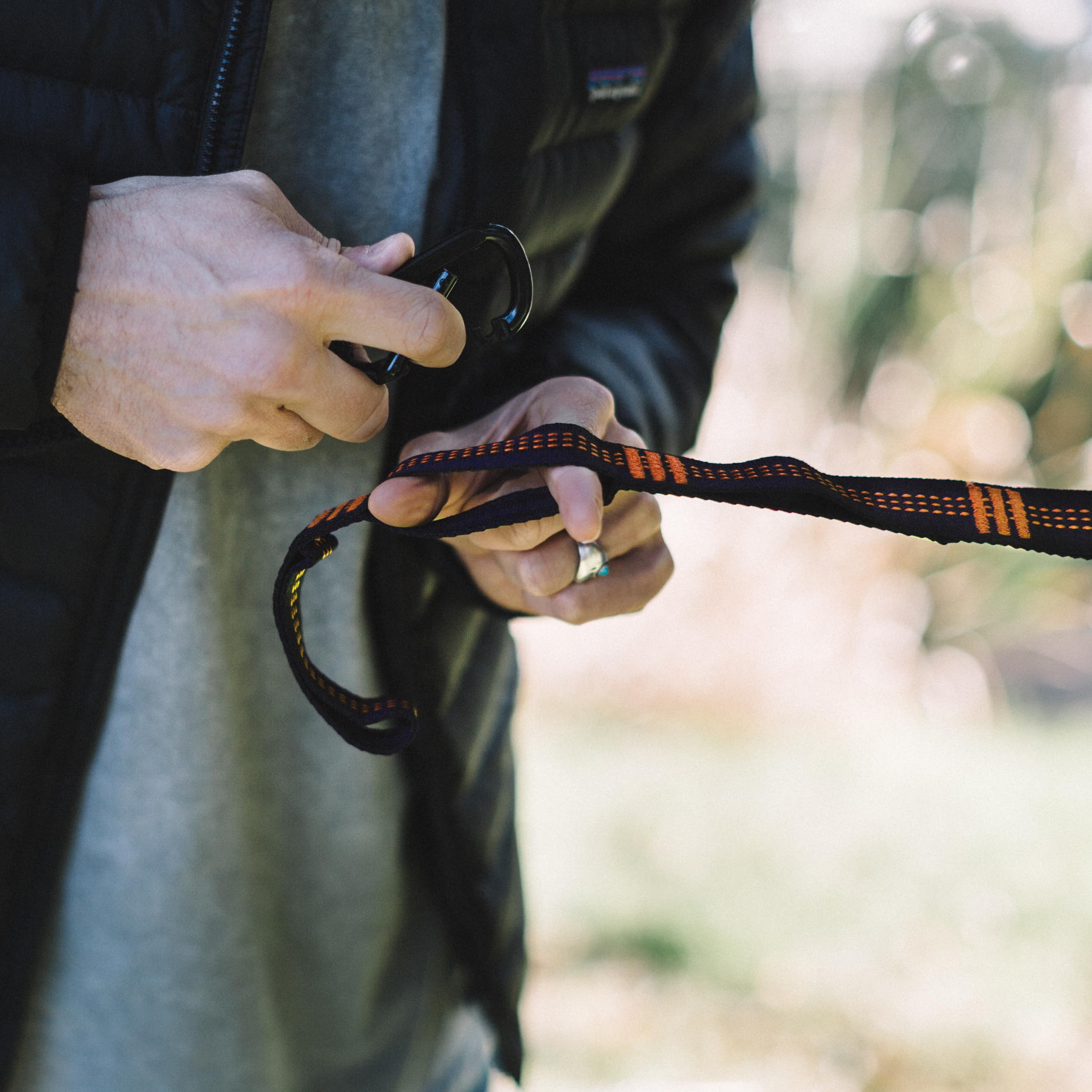 User setting up hammock with Wise Owl Outfitters straps