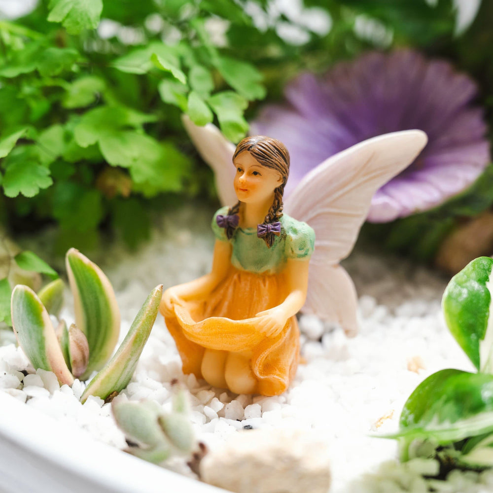 Various PRETMANNS fairy garden figurines arranged together