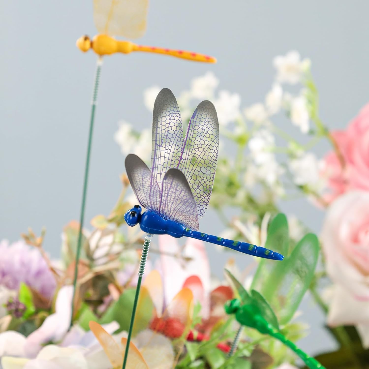 VGOODALL dragonfly stakes in a colourful flower bed