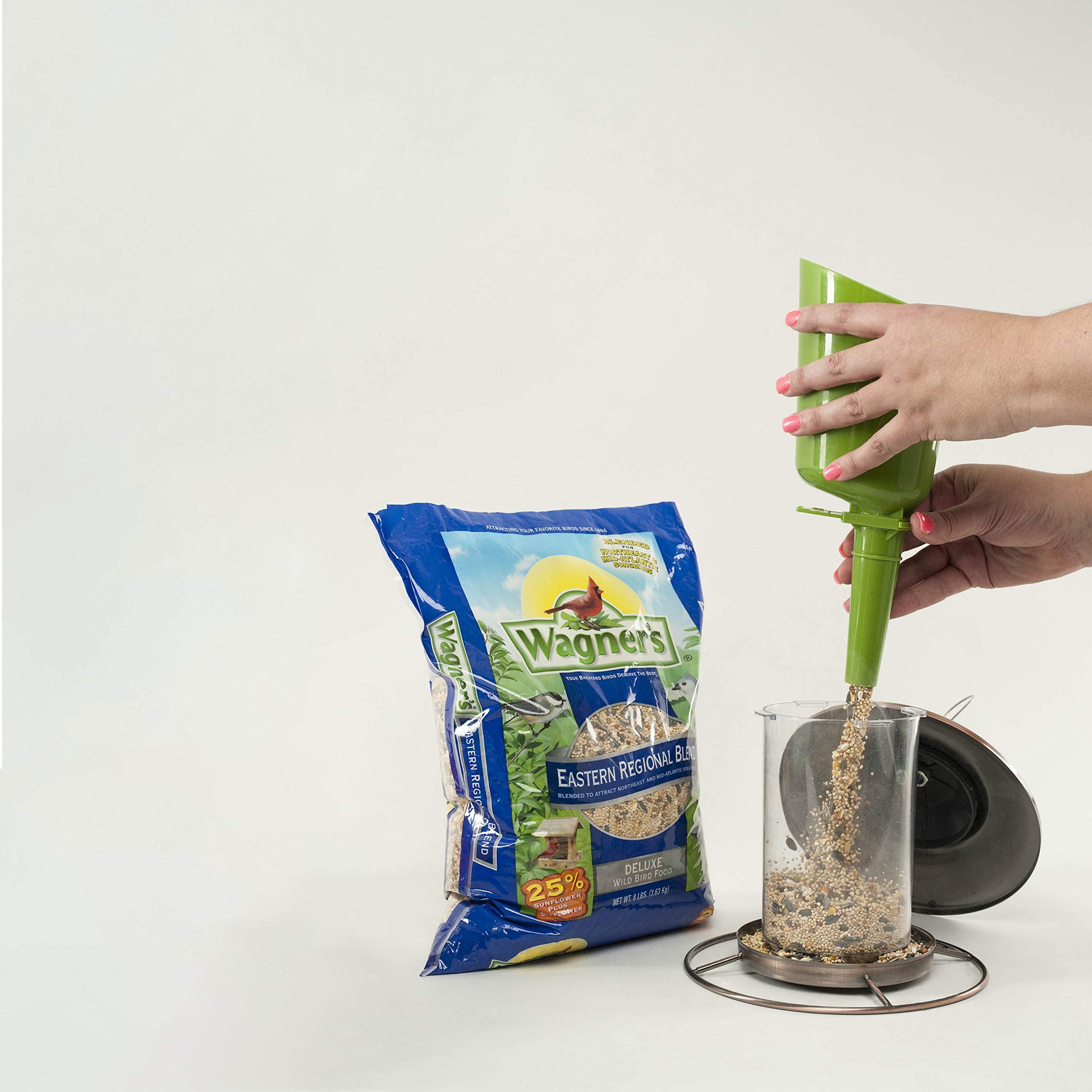 Wagner's Eastern Regional Blend Wild Bird Food being poured into a feeder