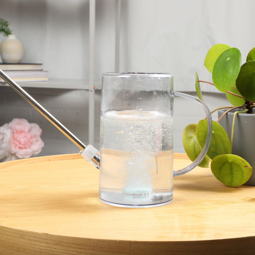 Watering can with dissolved INSTANT BIOLOGICS fertilizer tablet
