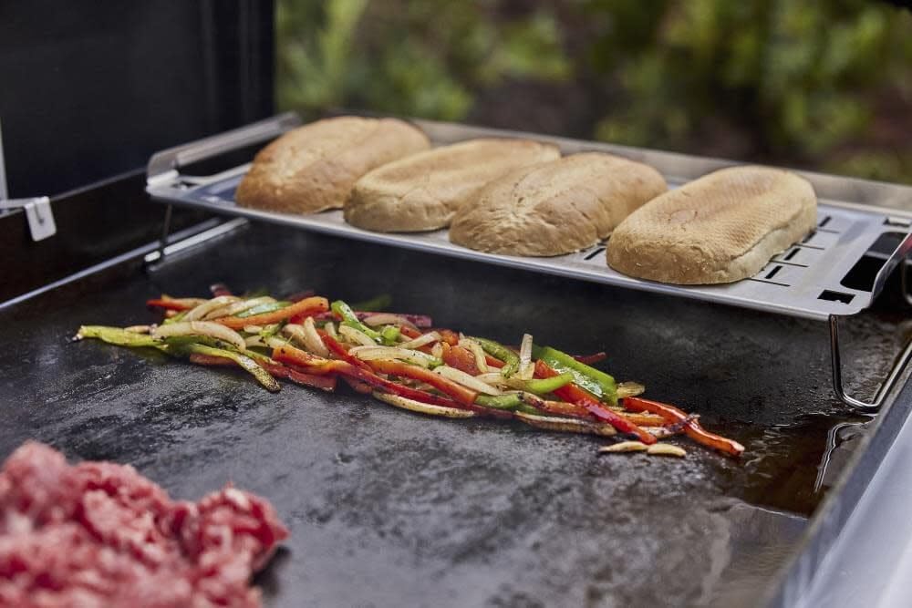 Weber Griddle Keep Warm Rack side view showing collapsible legs