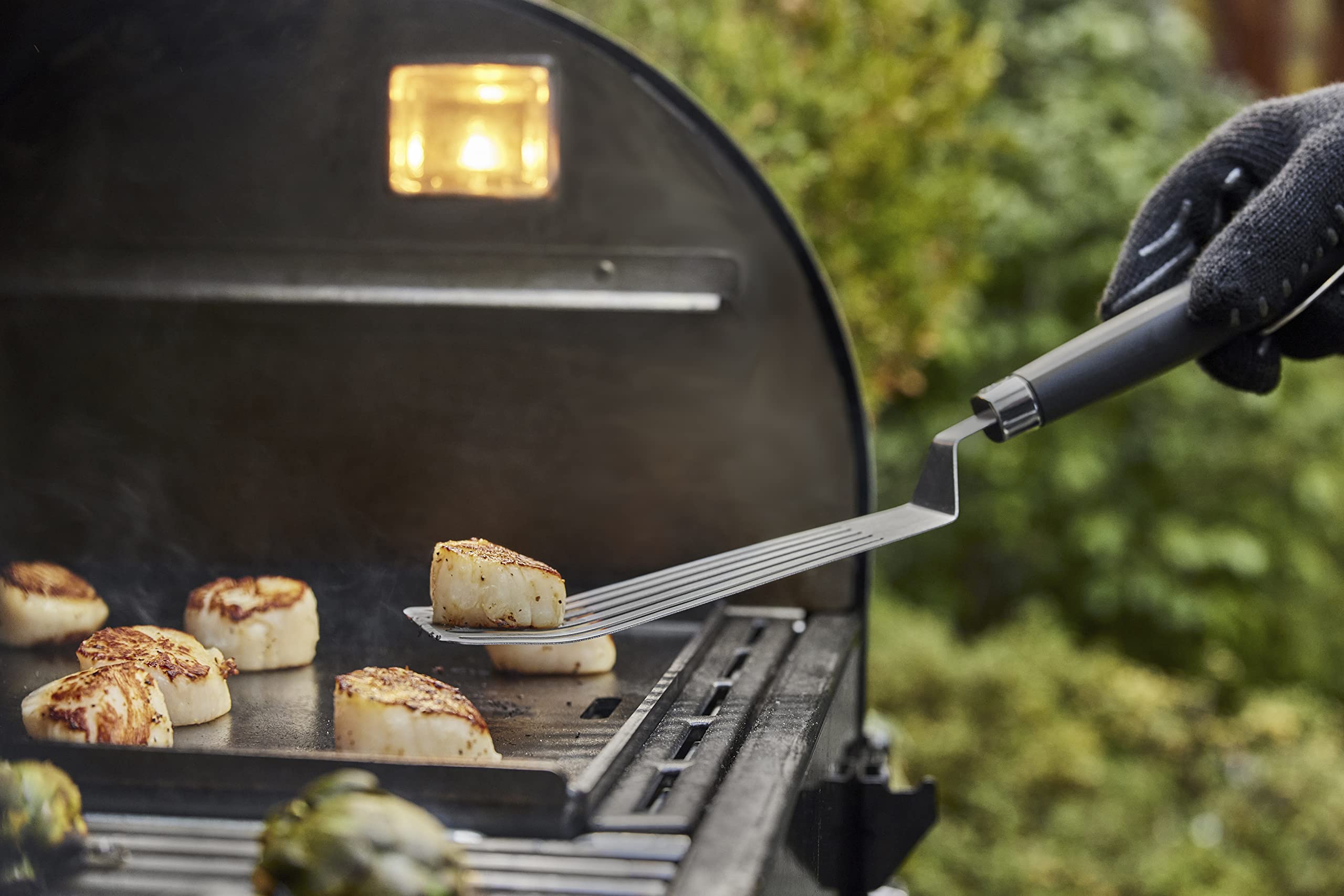Weber Griddle Spatula in use flipping food