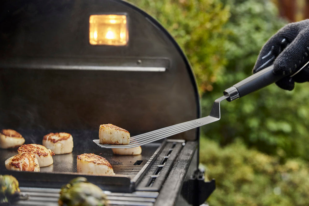 Weber Griddle Spatula in use flipping food