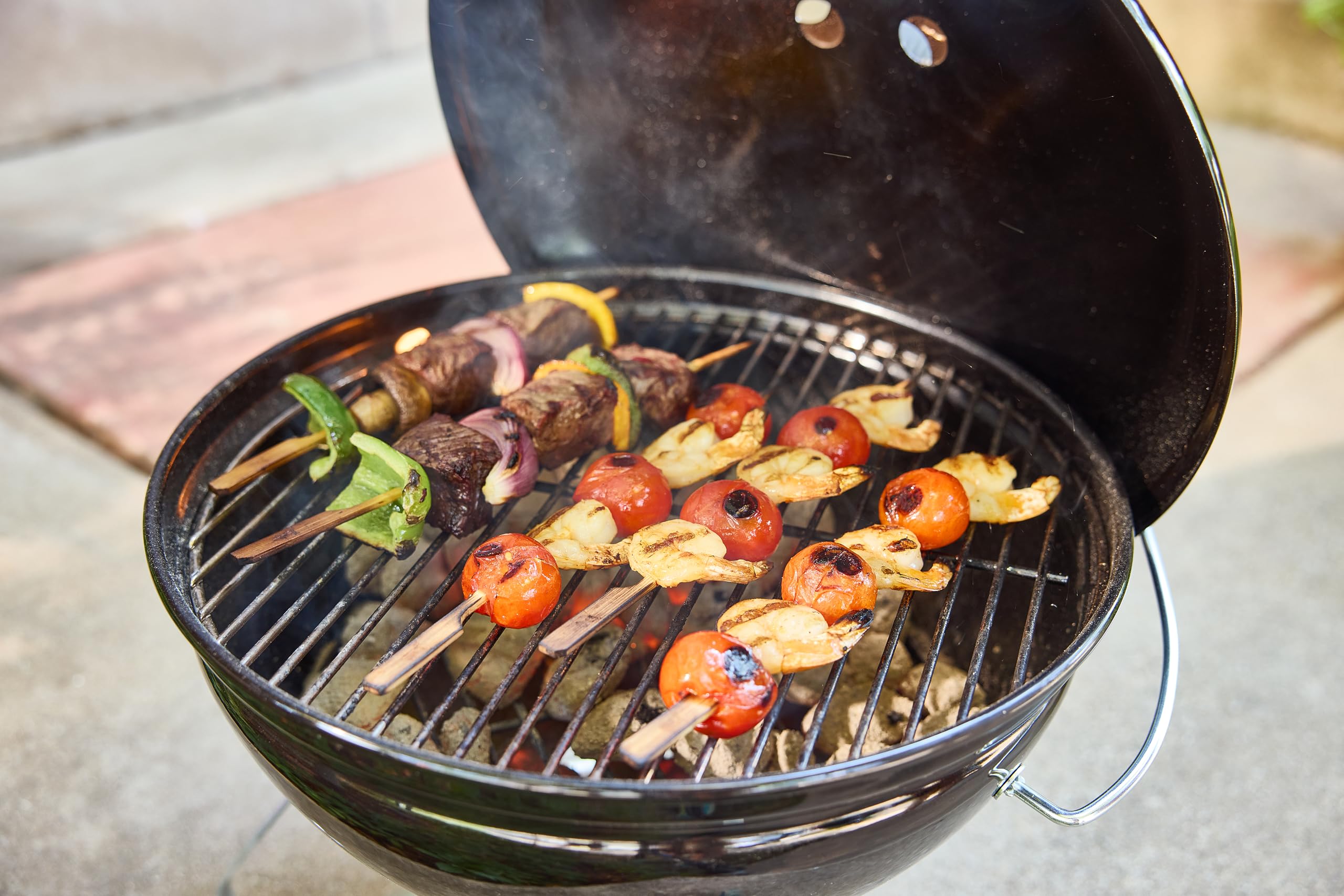 Weber Smokey Joe 14-Inch Portable Charcoal Grill with burgers cooking on grill