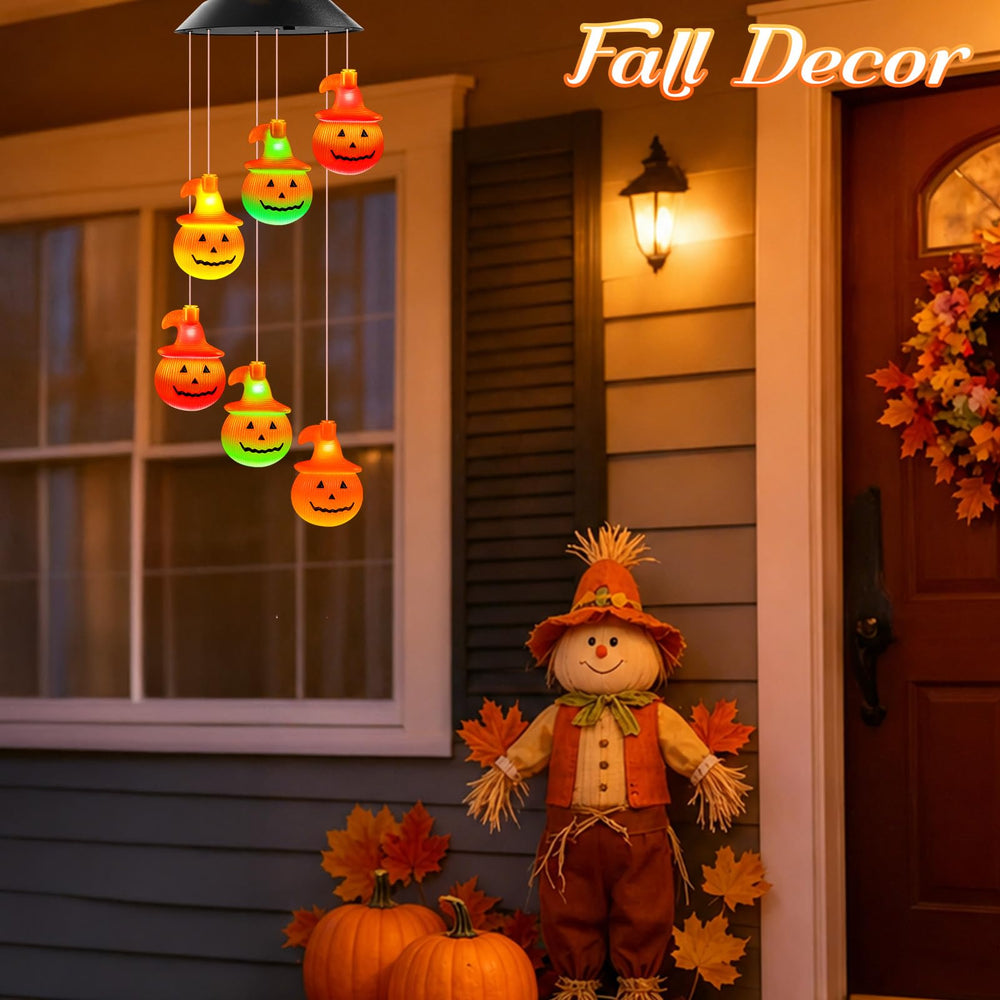 Winzwon Solar Pumpkin Wind Chimes hanging in a garden