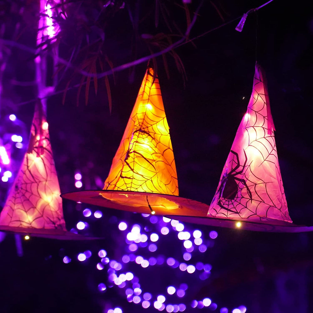 Witch hats displayed on a table with warm white lights