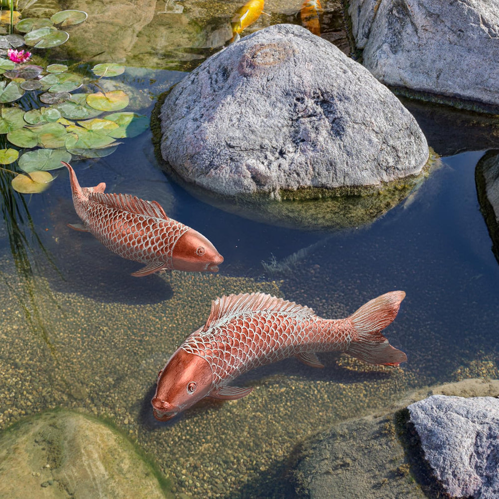 Wosuine Koi Fish Garden Statues in front of a flower bed