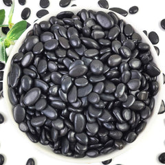 YISZM 2LB black polished pebbles displayed in a garden setting