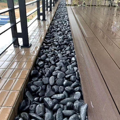 YISZM Black Pebbles displayed in an aquarium setting