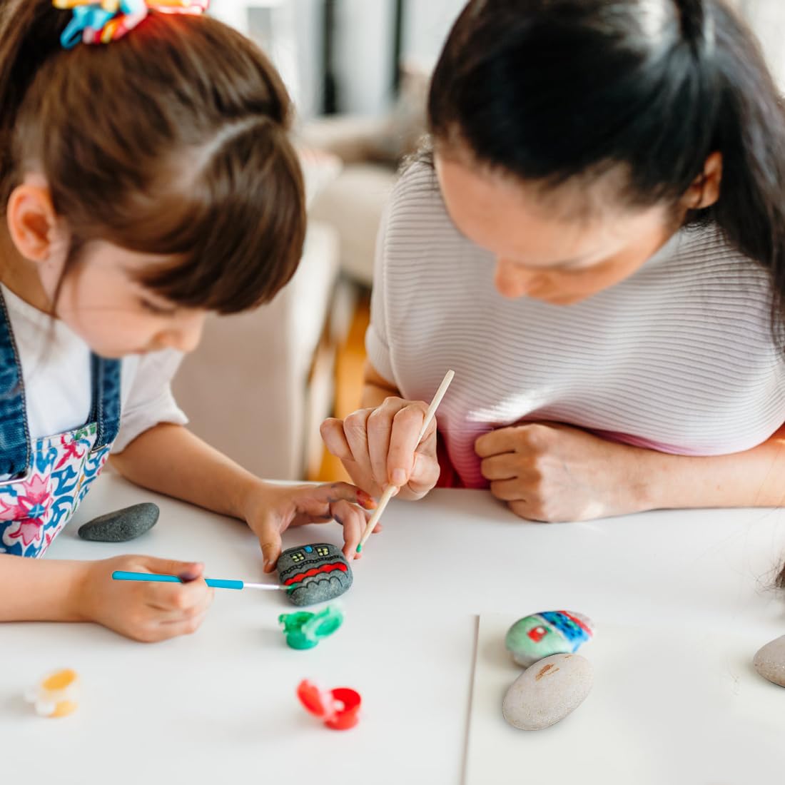 YISZM painting stones with paintbrushes and paints