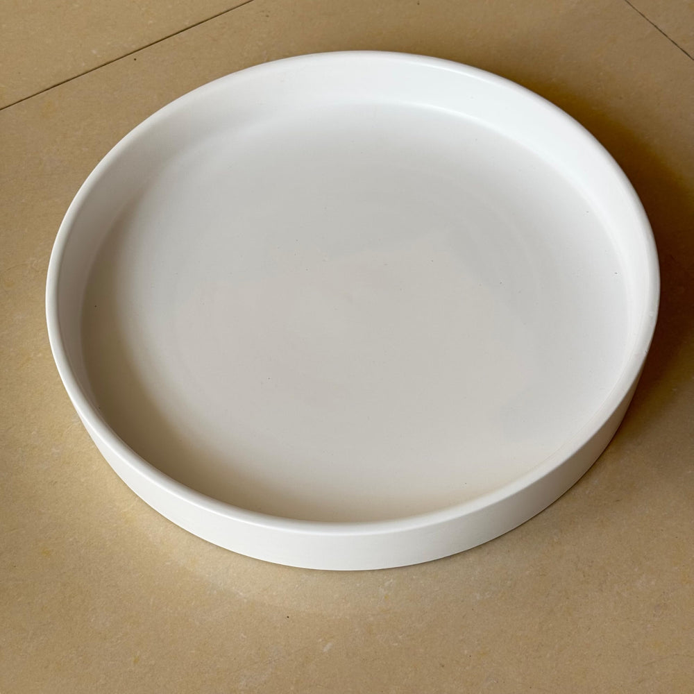 Yukfona plant saucer with potted plant on a table