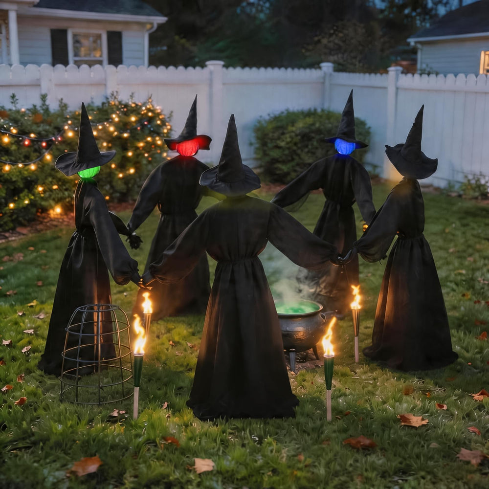 Zesua witches displayed in a garden setting
